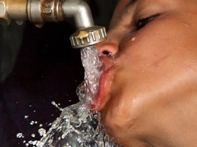 Ein palästinensischer Junge trinkt im Gazastreifen aus einem Wasserhahn. Wasser