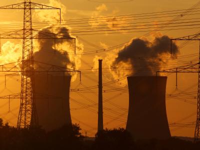 Das Licht der untergehenden Sonne fällt auf die Kühltürme eines Atomkraftwerks. Atomkraftwerk