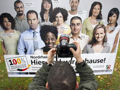 Plakat zu einer Einbürgerungskampagne: Die Koalition ist beim Thema Zuzug von Fachkräften aus dem Ausland noch uneinig. Lockprämie für ausländische Fachkräfte