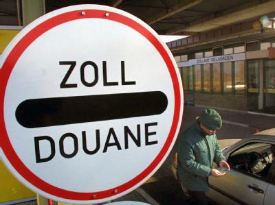 Ein Zollbeamter kontrolliert einen Autofahrer: Foto: Patrick Seeger/ Archiv Schengen-Reform