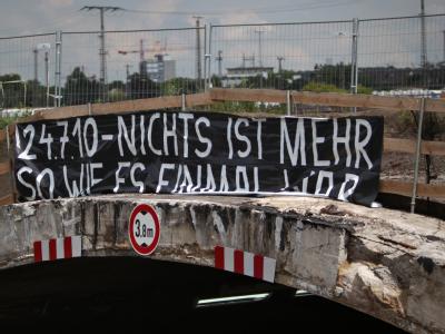 Über dem Eingang zum Tunnel hängt in Duisburg an der Unglücksstelle der Loveparade-Massenpanik ein Banner. Tote bei Loveparade - Trauer