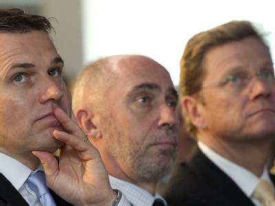 Der Lebensgefährte von Bundesaußenminister Westerwelle, Michael Mronz (l-r), der deutsche Botschafter in Argentinien, Günter Rudolf Knieß und Bundesaußenminister Guido Westerwelle (FDP) besuchen das Volkswagen-Werk Argentinia in Buenos Aires. Westerwelle und Lebensgefährte Mronz