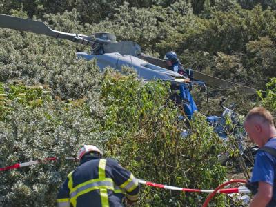 Die Feuerwehr sichert den Unglücksort in den Dünen von Maasvlakte, nahe Rotterdam. Hubschrauber stürzt bei Rotterdam ab
