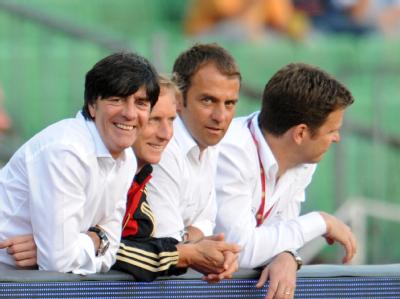 Trainer Joachim Löw (l) steht vor dem Länderspiel gegen Ungarn im Mai 2010 zusammen mit dem Psychologen Hans Dieter Hermann (2.v.l), dem Co-Trainer Hansi Flick (2.v.r) und dem Manager Oliver Bierhoff (r) an der Bande. Löw und Bierhoff