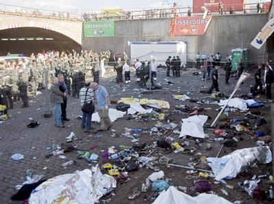 Mit Tüchern bedeckte Tote liegen in Duisburg vor dem Tunnel. Tote bei Loveparade 2010 in Duisburg