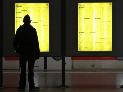 Ein Reisender informiert sich über seine Zugverbindung. Fahrplan
