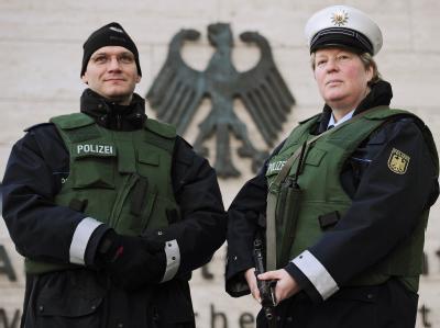 Polizisten stehen in kugelsicheren Westen und mit Maschinenpistole vor dem Auswärtigen Amt in Berlin. Sicherheitsmaßnahmen