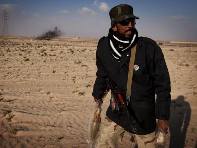 Ein libyscher Rebell bringt sich nach Angriffen der Gaddafi-Truppen in Adschdabija in Sicherheit. Libyscher Rebell in Adschdabija