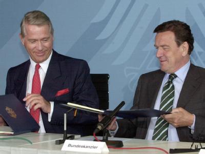 Bundeskanzler Gerhard Schröder (SPD) und der damalige eon-Vorstandsvorsitzende Ulrich Hartmann (l.) tauschen die Grundsatzvereinbarung über den Ausstieg aus der Atomenergie am 11.06.2001 im Berliner Kanzleramt aus. Atomausstieg 2001