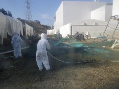 Helfer sprühen Kunstharz auf dem Gelände des havarierten Atomkraftwerkes im japanischen Fukushima aus, um radioaktiven Staub zu binden. Fukushima