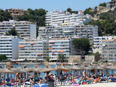 Sonnenschirme, Liegen und Touristen am Strand von Costa de la Calma auf Mallorca (Archiv). Hotelanlagen auf Mallorca