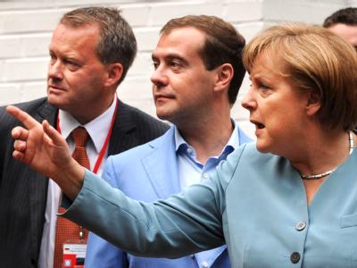 Angela Merkel zeigt, wo es langgeht: Während der Deutsch-Russischen Regierungskonsultationen spaziert die Bundeskanzlerin mit dem russischen Präsidenten Dmitri Medwedew durch den Garten eines Landhauses bei Hannover. Foto: Peter Steffen, dpa Da lang!