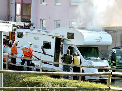 Feuerwehrleute und Polizisten stehen in Eisenach vor dem Wohnwagen, in dem zwei Leichen entdeckt wurden. Foto: Carolin Lemuth Zwei Leichen in Wohnmobil gefunden