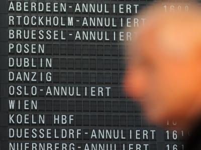 Ein Flugreisender steht in Terminal 1 des Flughafens von Frankfurt am Main vor einer Anzeigetafel, auf der annullierte Flüge angezeigt werden. Foto: Arne Dedert Gewerkschaft will Frankfurter Flughafen bestreiken