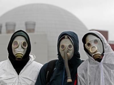 Demonstranten mit Gasmasken stehen am AKW Brokdorf. Foto: Malte Christians Anti-Atom Demonstration in Brokdorf