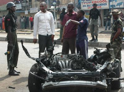 Polizisten in Kaduna untersuchen das Auto, das mit Sprengstoff gefüllt war und explodierte. Foto: str/epa Anschlag im Norden Nigerias