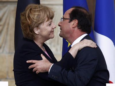 Kanzlerin Merkel und Präsident Hollande begrüßen sich in Reims. Foto: Jacky Naegelen Umarmung