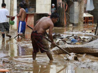 Nach den verheerenden Überschwemmungen auf den Philippinen steigt die Opferzahl weiter. Foto: Rolex Dela Pena Aufräumarbeiten