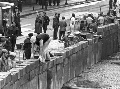 Unter der Aufsicht von bewaffneten Volkspolizisten errichtet eine Ostberliner Maurerkolonne am 18.8.1961 am Potsdamer Platz eine mannshohe Mauer. Mauerbau