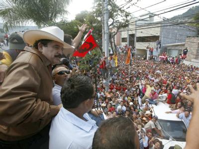 Manuel Zelaya (L) winkt von der brasilianischen Botschaft in Tegucigalpa seinen Anhängern zu. Zelaya vor Anhängern