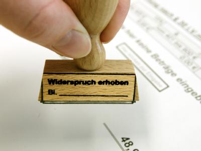 In der Widerspruchsstelle für Hartz IV der Arbeitsgemeinschaft Leipzig hält eine Mitarbeiterin einen Stempel für Eingänge von Widersprüchen in der Hand. Widersprüche gegen Hartz IV