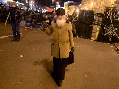 Ein Priester hat sich auf dem Maidan-Platz zwischen die Linien gewagt. Foto: Filip Singer Deeskalation