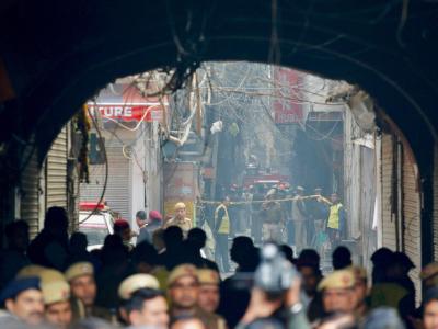 Ein Feuerwehrwagen steht in einer engen Gasse vor dem Unglücksort in Neu Delhi. Großbrand in Neu Delhi